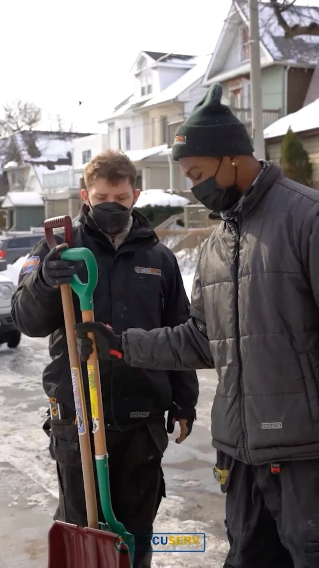 AccuServ team at a winter renovation, still from its project video.