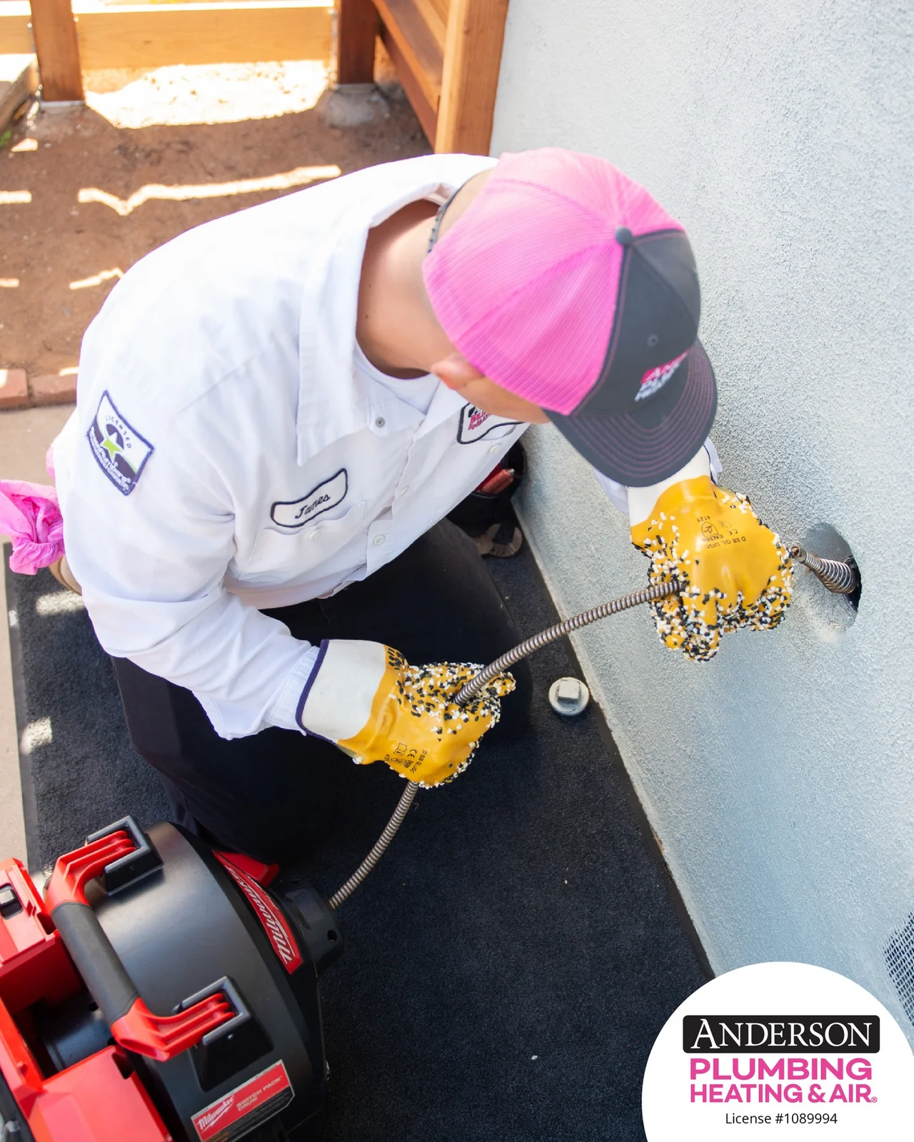 Anderson technician using drain-cleaning equipment.