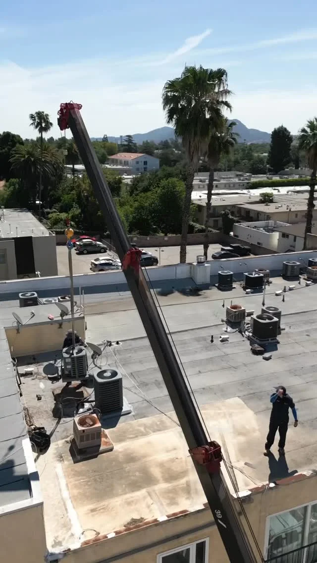 Brody Pennell rooftop HVAC project with a crane — Instagram video still.