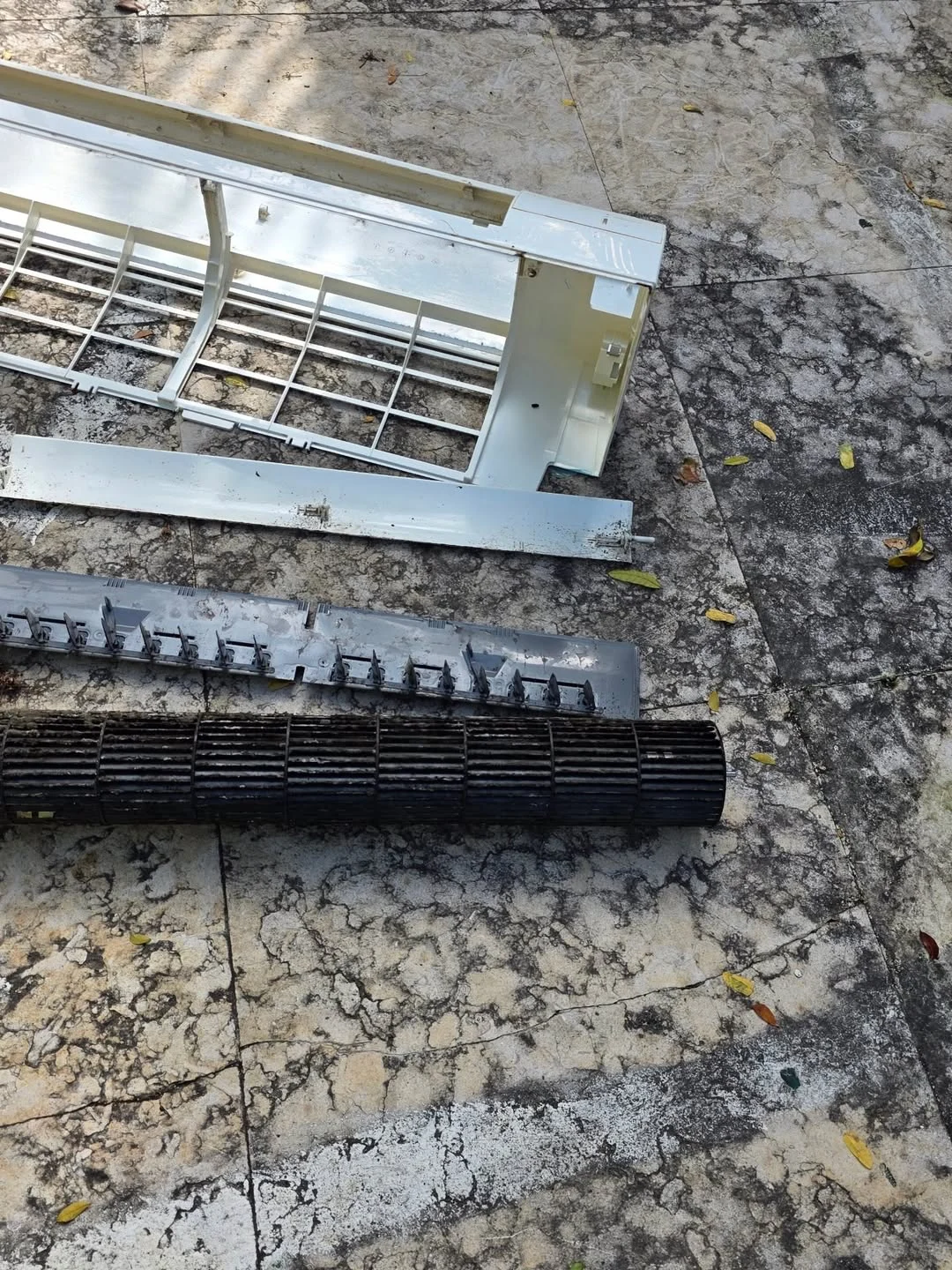 Disassembled mini-split housing and blower wheel during Coldlife AC maintenance in Miami Beach.