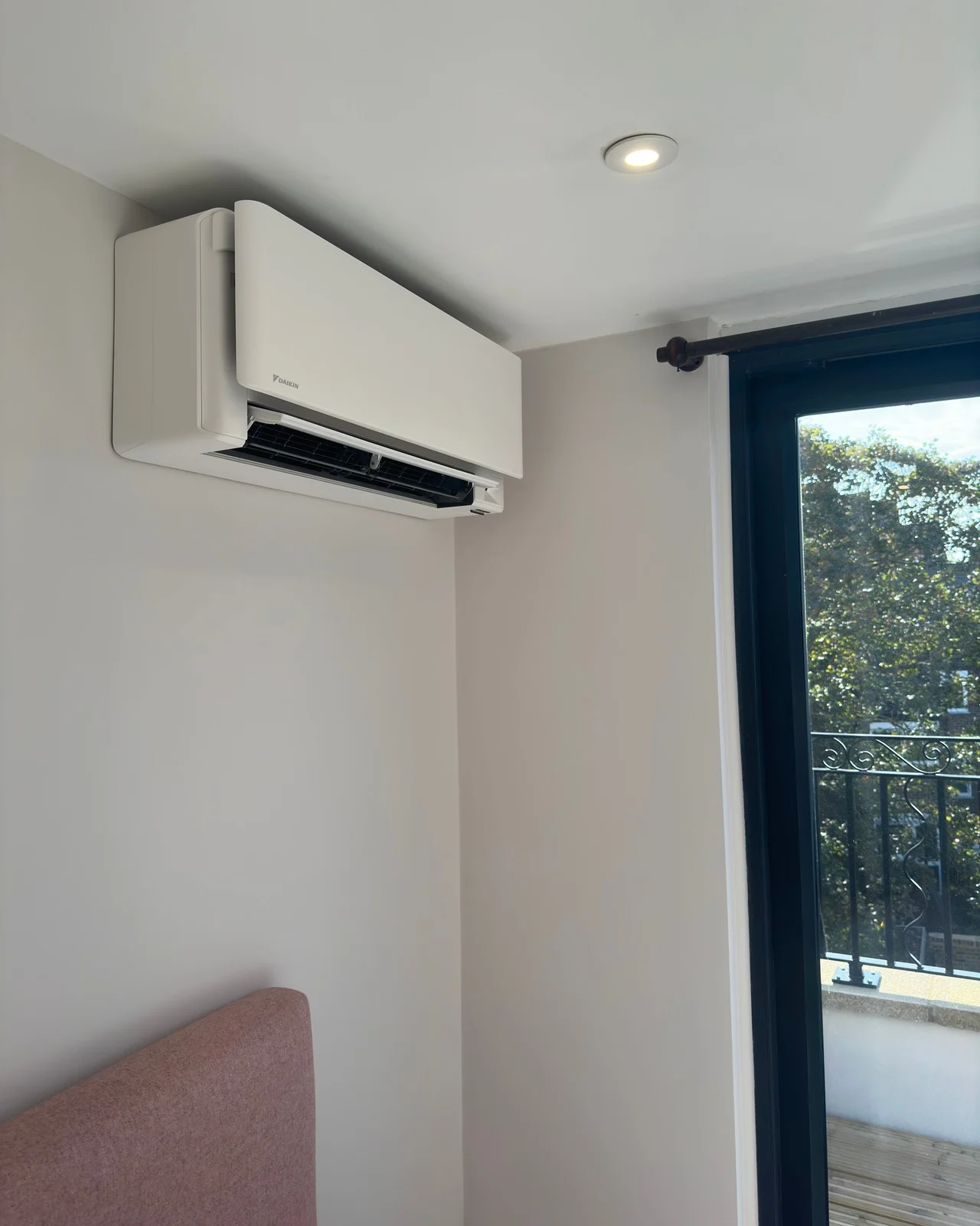Completed attic-room air-conditioning installation in a London townhouse.