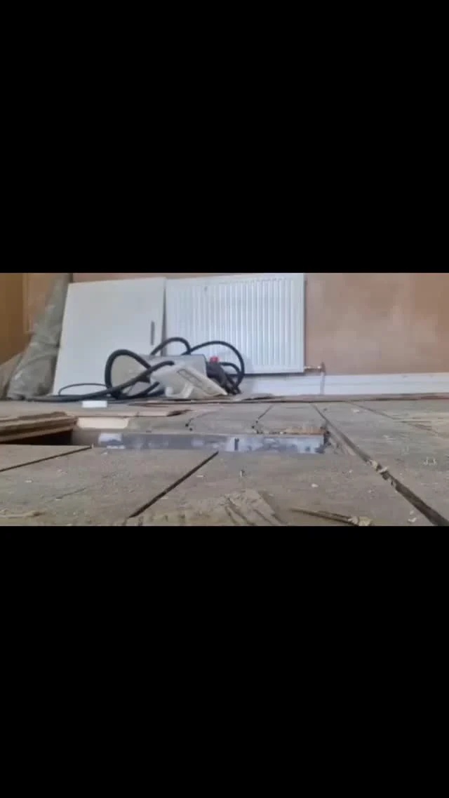 Pipework installed beneath floorboards during a boiler relocation — Instagram video still.