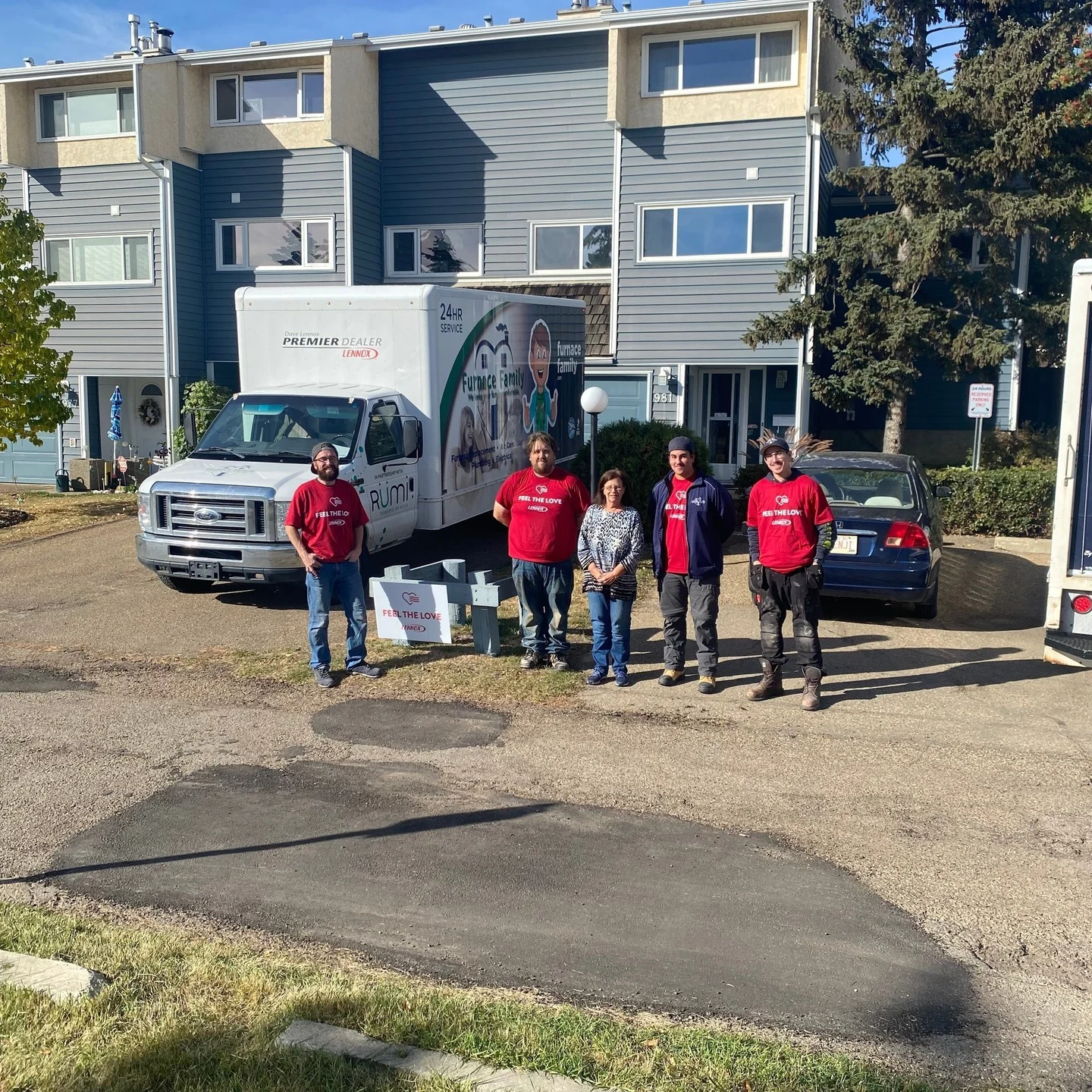 Furnace Family crew beside their truck during a Lennox Feel the Love installation.