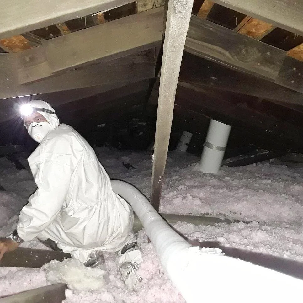 LC Heating and Air technician working in an attic.
