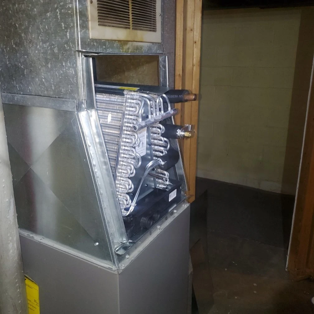 Custom sheet-metal ductwork and cooling-coil installation.